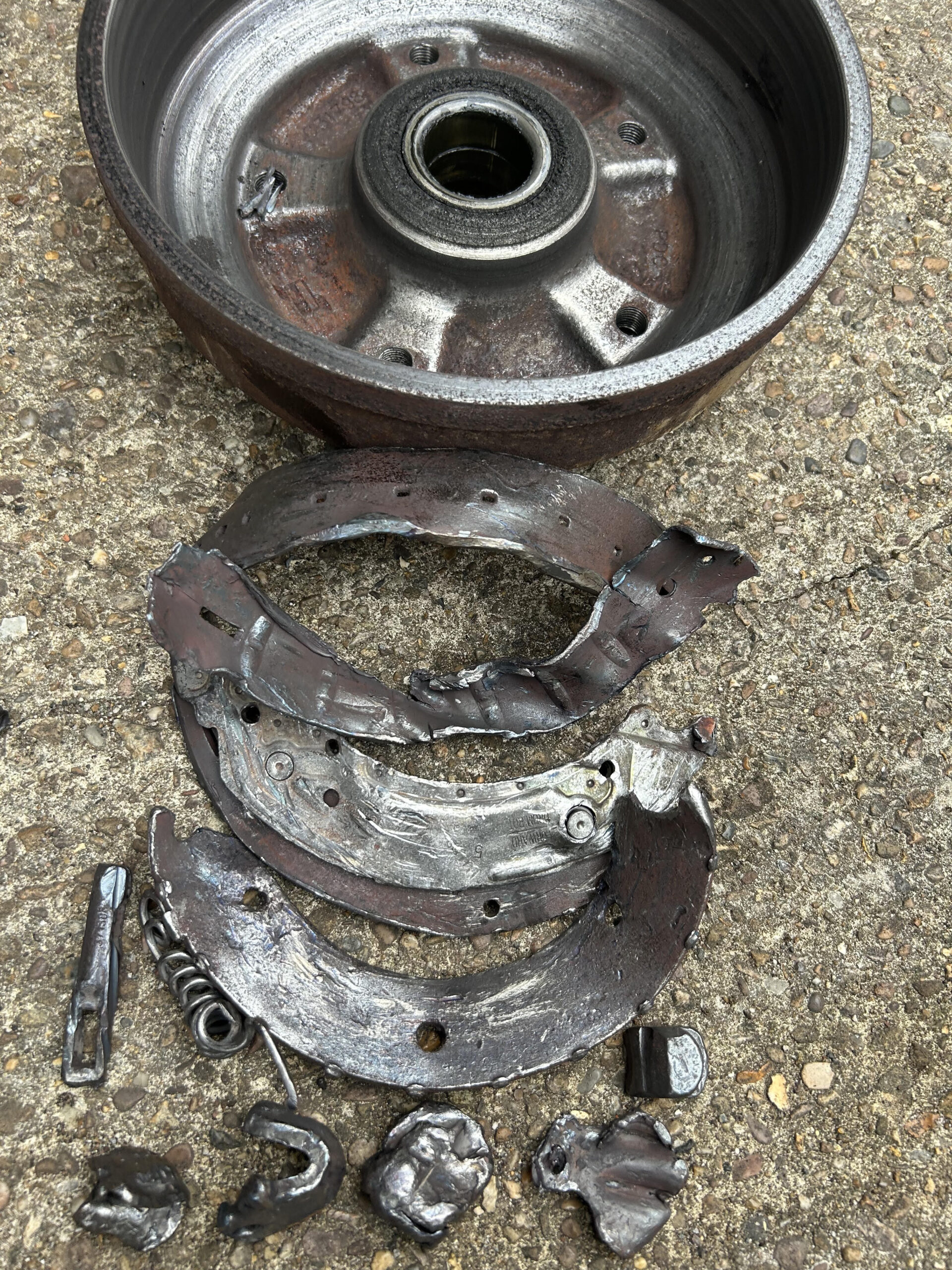 Ifor Williams trailer brakes with detached brake shoes and damaged brake drum